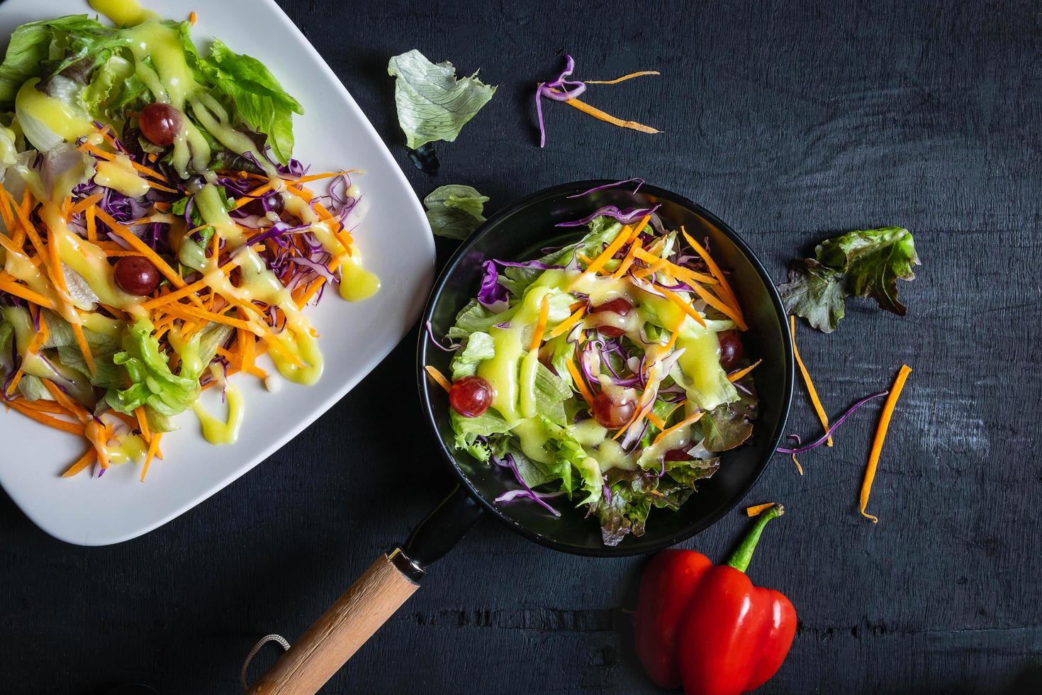 Bowl of vegetable salad on black table photo