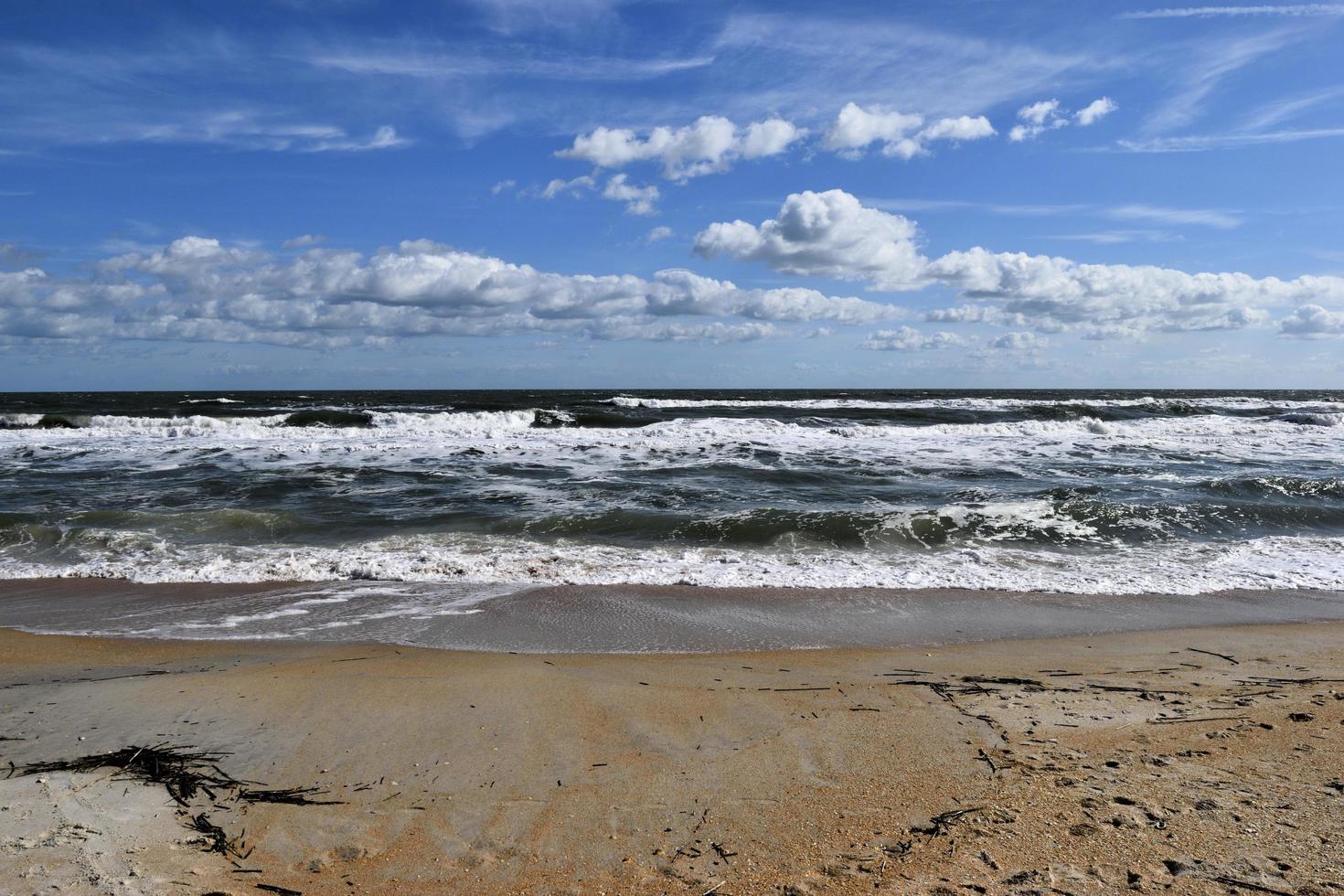 Waves crashing at the beach photo