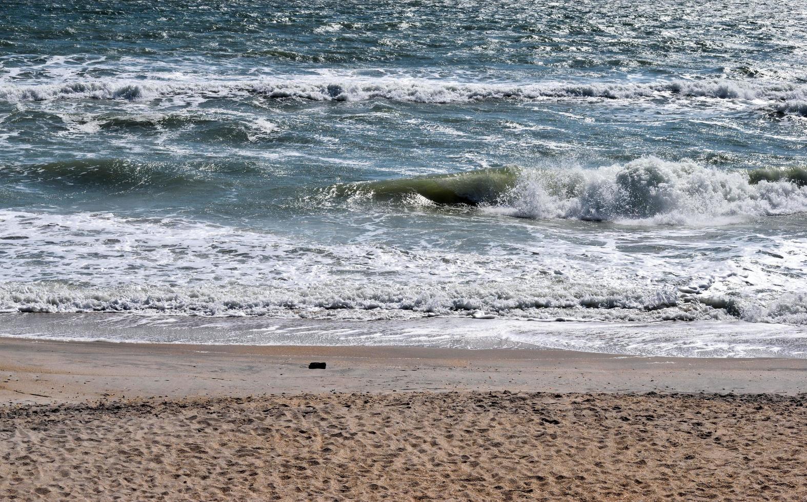 Ocean waves crashing at the beach photo