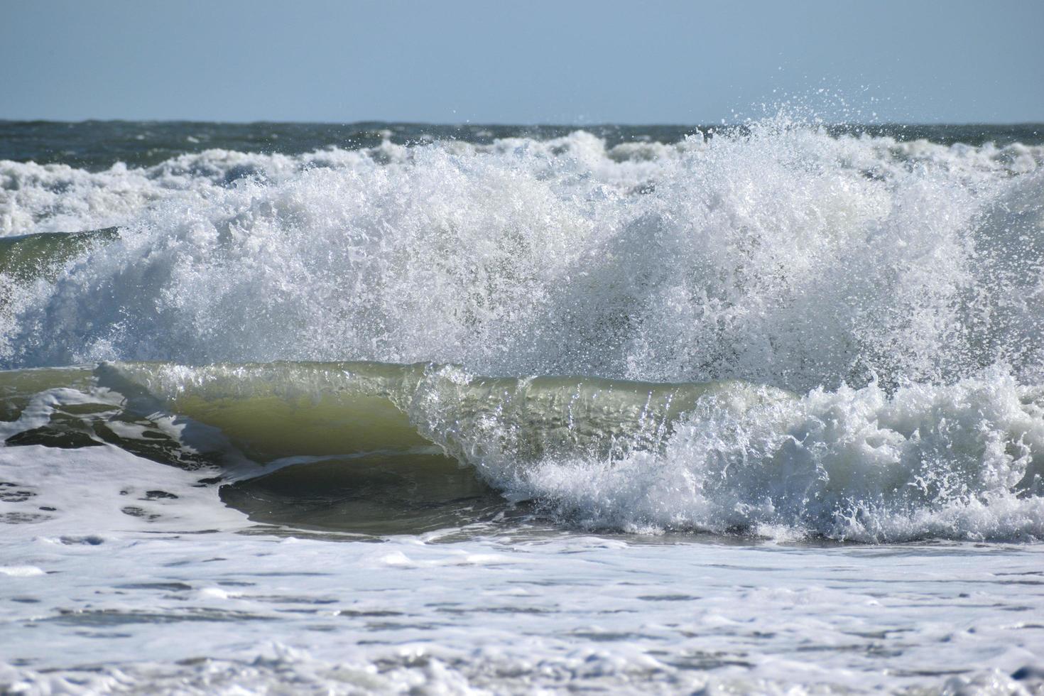 Ocean waves crashing at the beach photo