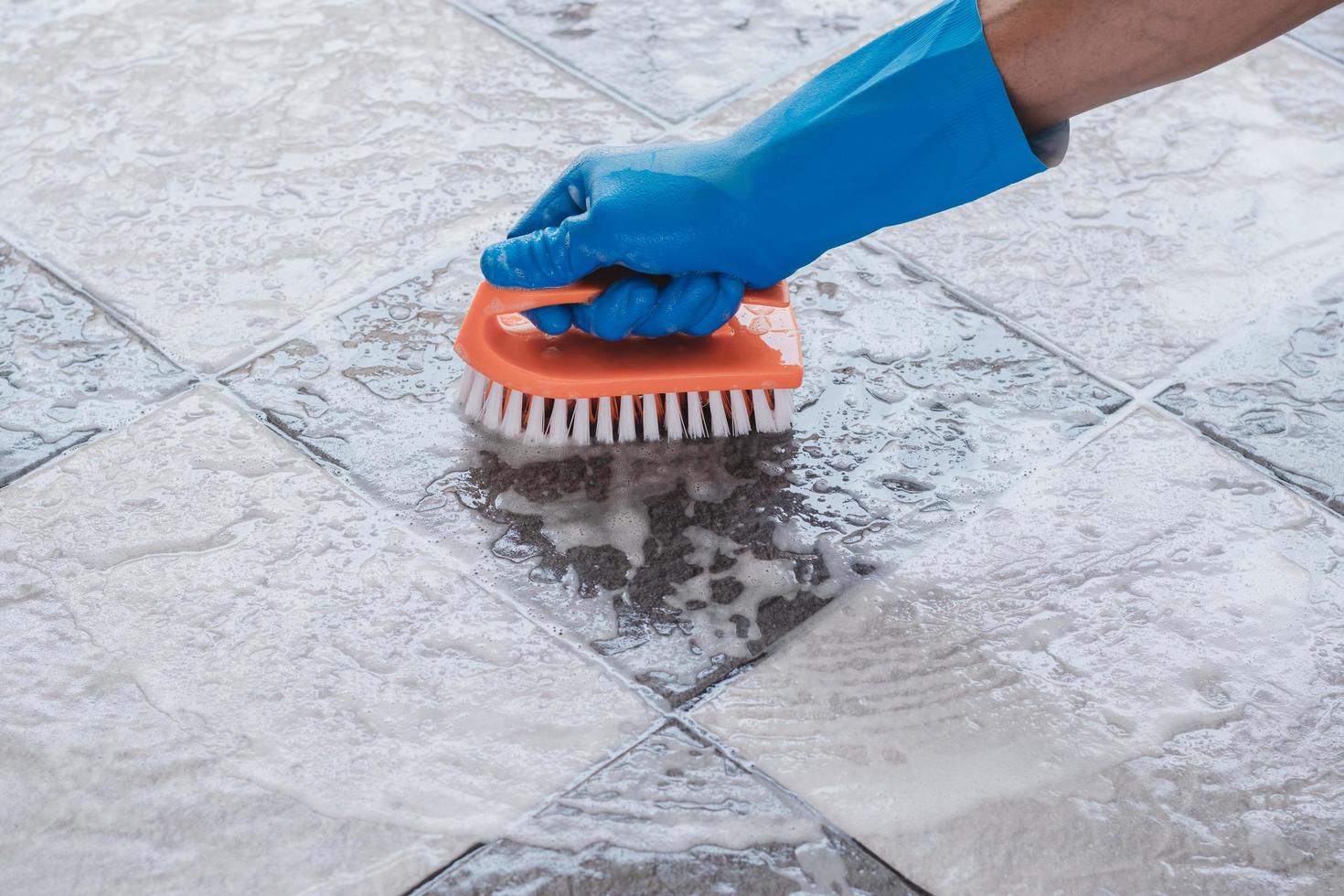 Close-up of person scrubbing a floor photo