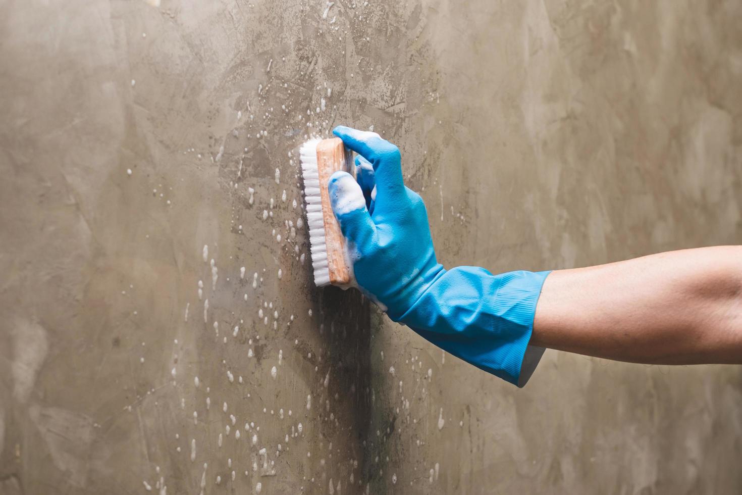 Person cleaning a wall photo