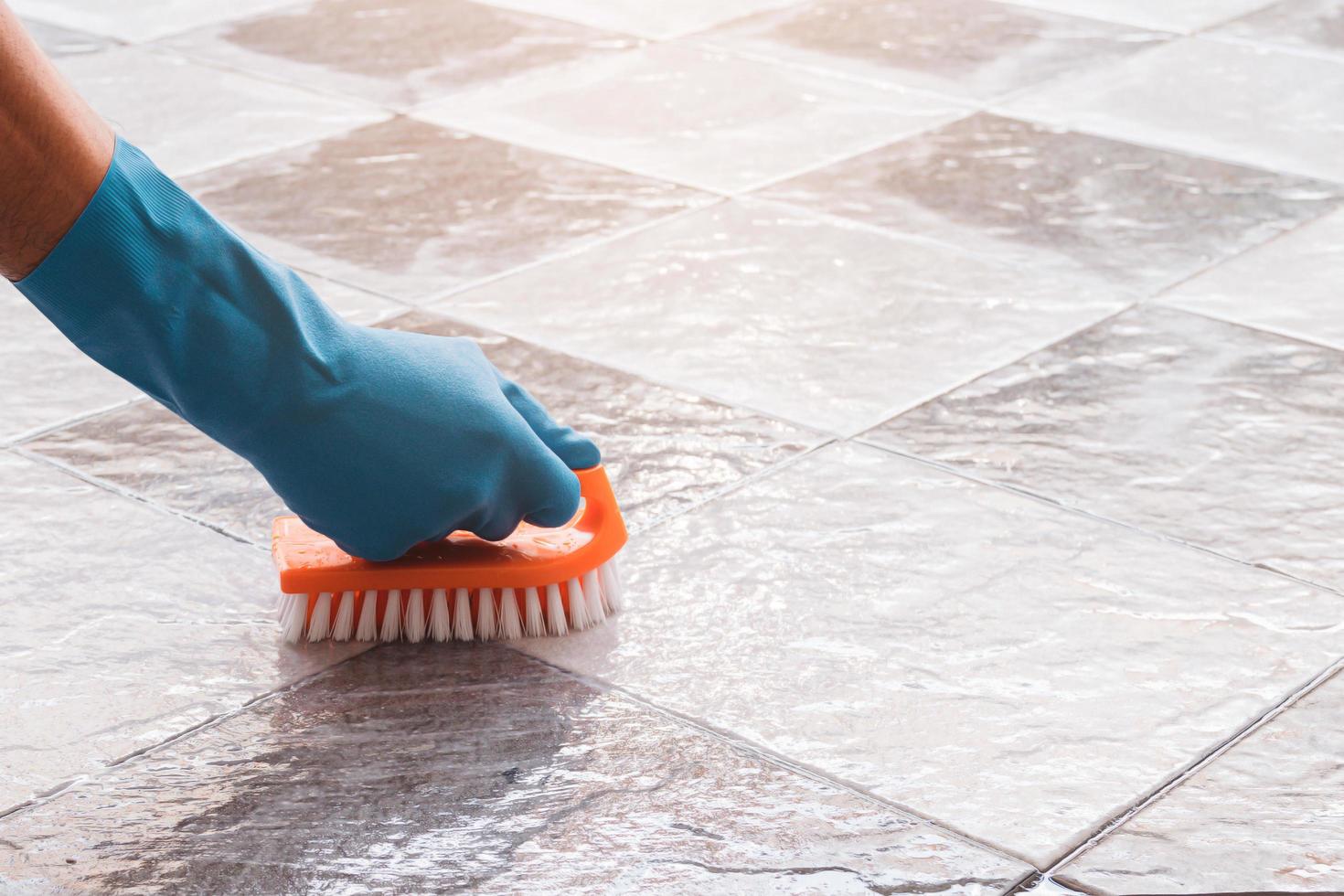 Close-up of a person cleaning tile photo