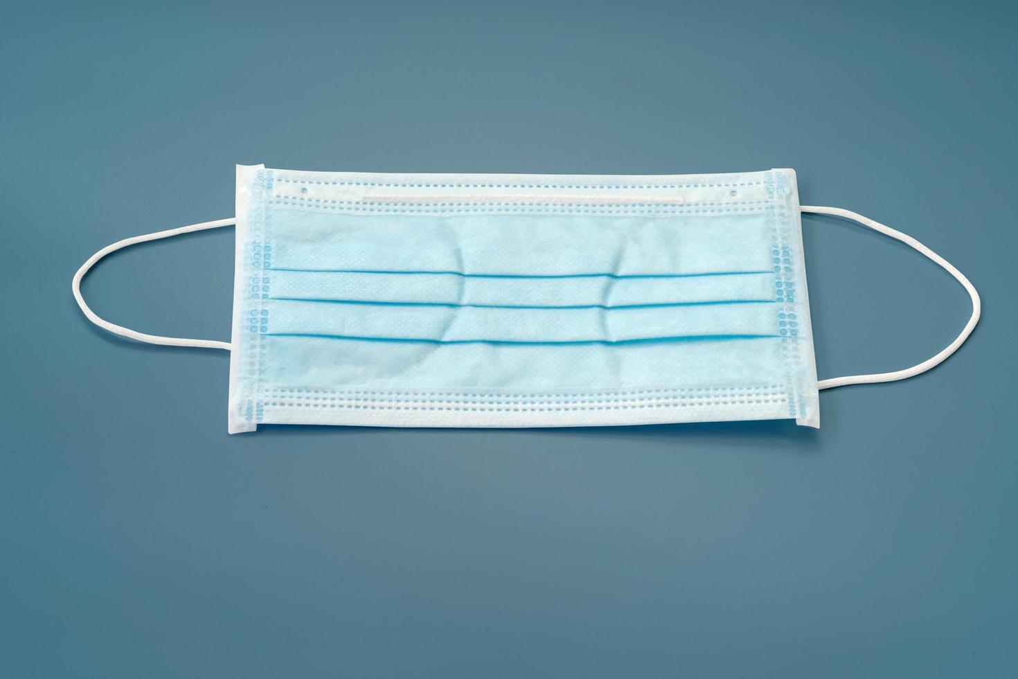 Close-up of a blue face mask on a blue background photo