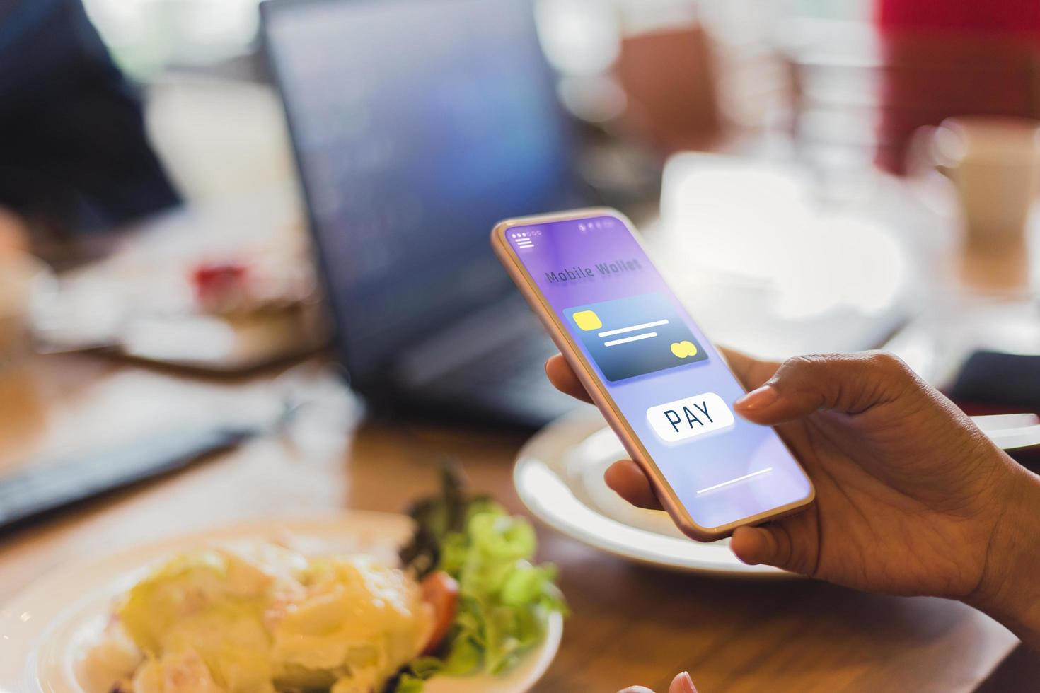 Woman pays for food using mobile phone  photo