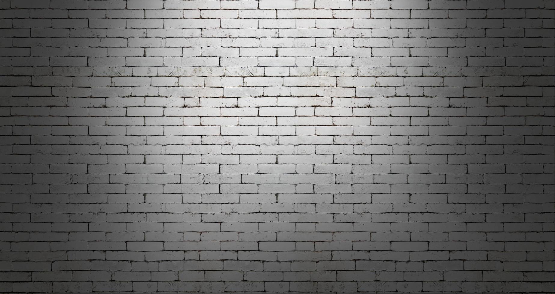 White brick wall on dark room background photo