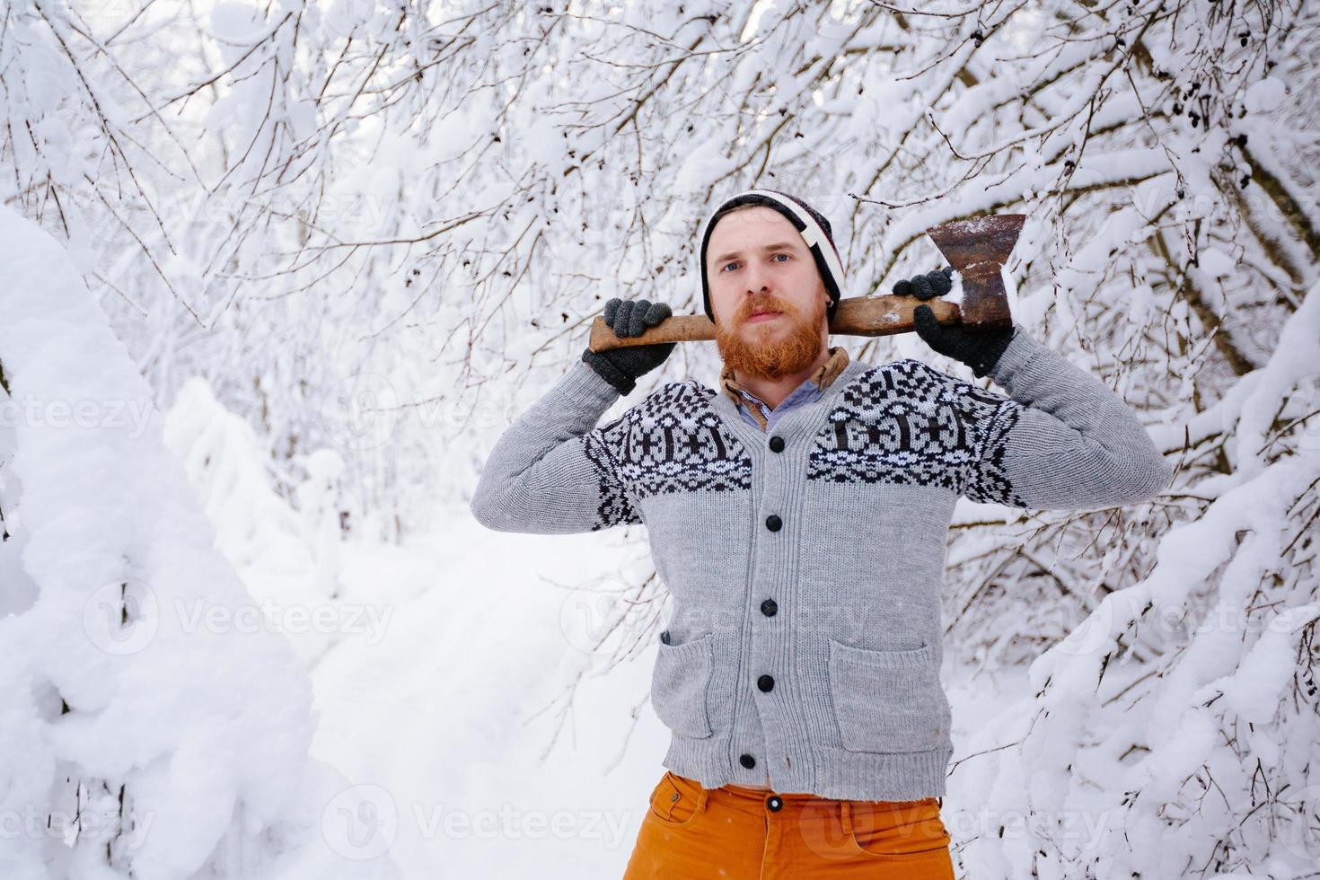 Lumberjack in the snowy winter forest photo