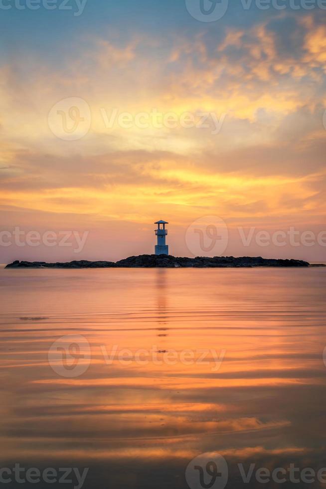 Seascape at sunset. Lighthouse on the coast photo