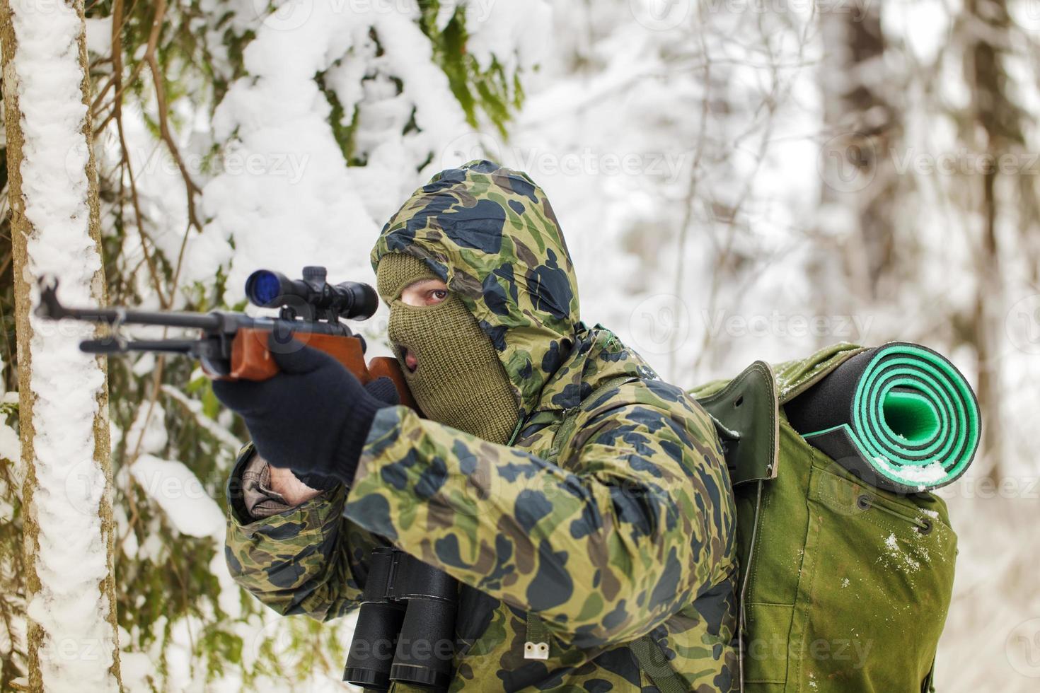 Hunter with optical rifle photo