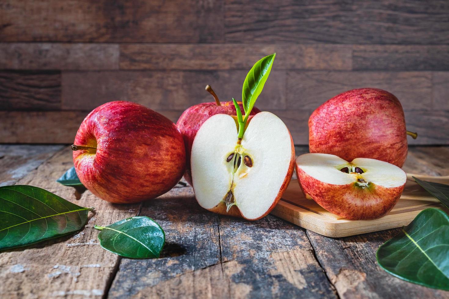 Red apples on a wooden table photo