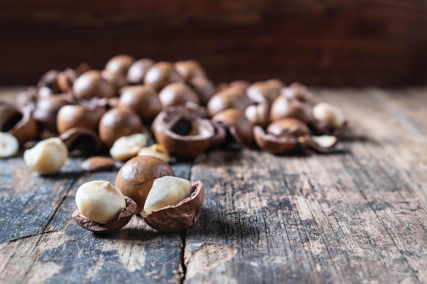 Macadamia nuts on wooden table photo