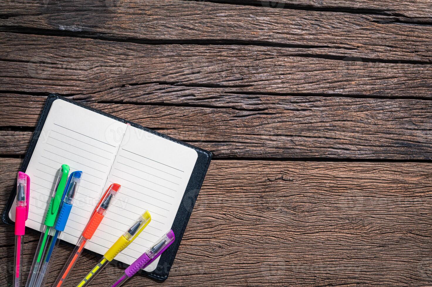 Colorful pens on a notepad photo