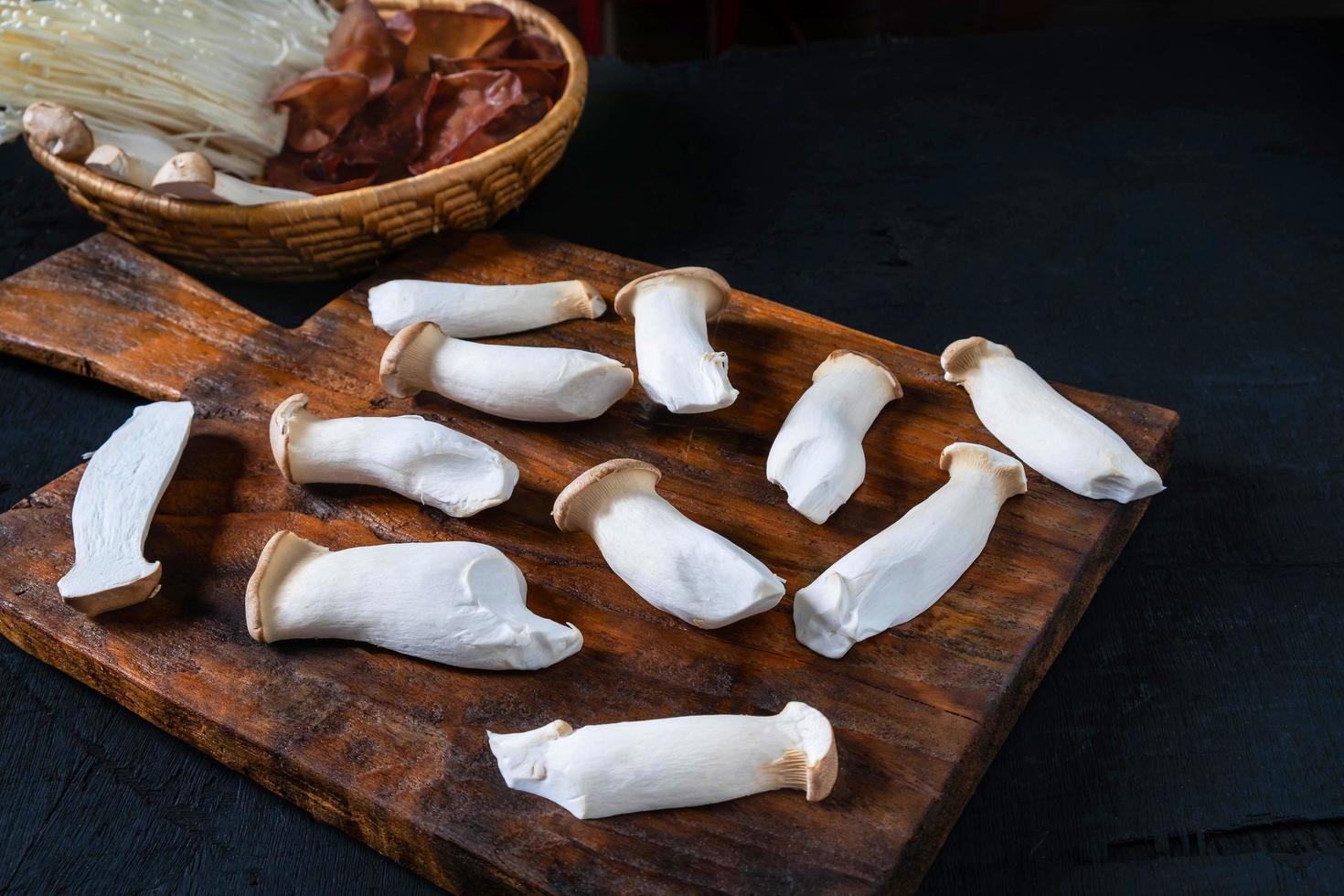 Fresh mushrooms on wood and in a bowl photo