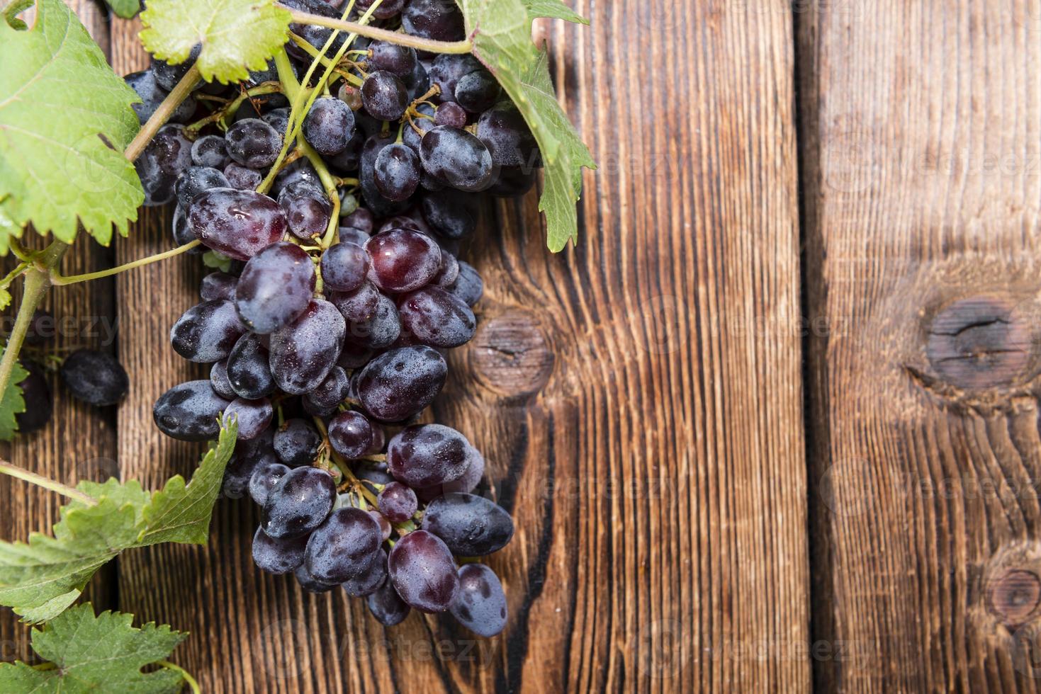 Blue Grapes (on wooden background) 1342793 Stock Photo at Vecteezy