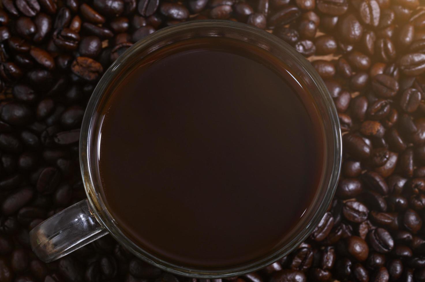 Mug of coffee on coffee beans photo