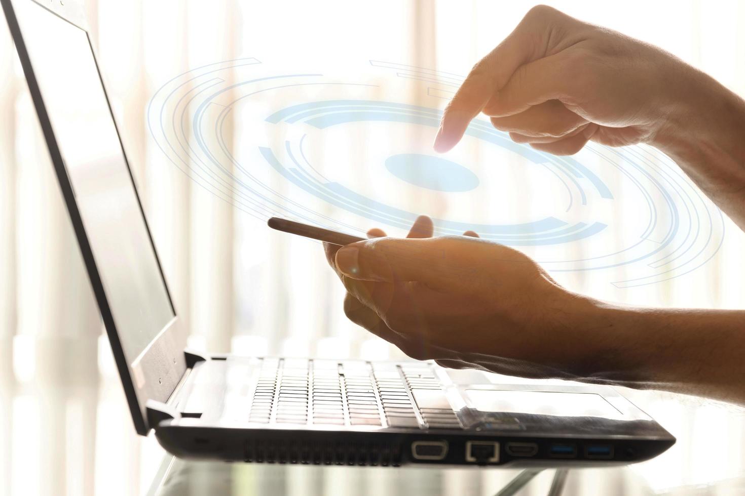 Businessmen using smartphone and laptop in the office photo