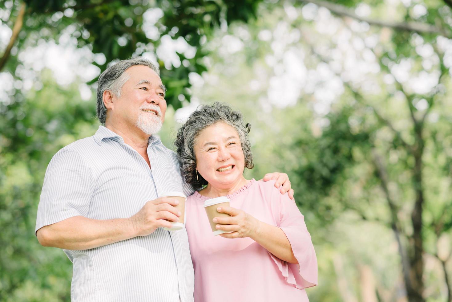 Happy older couple drink coffee together photo