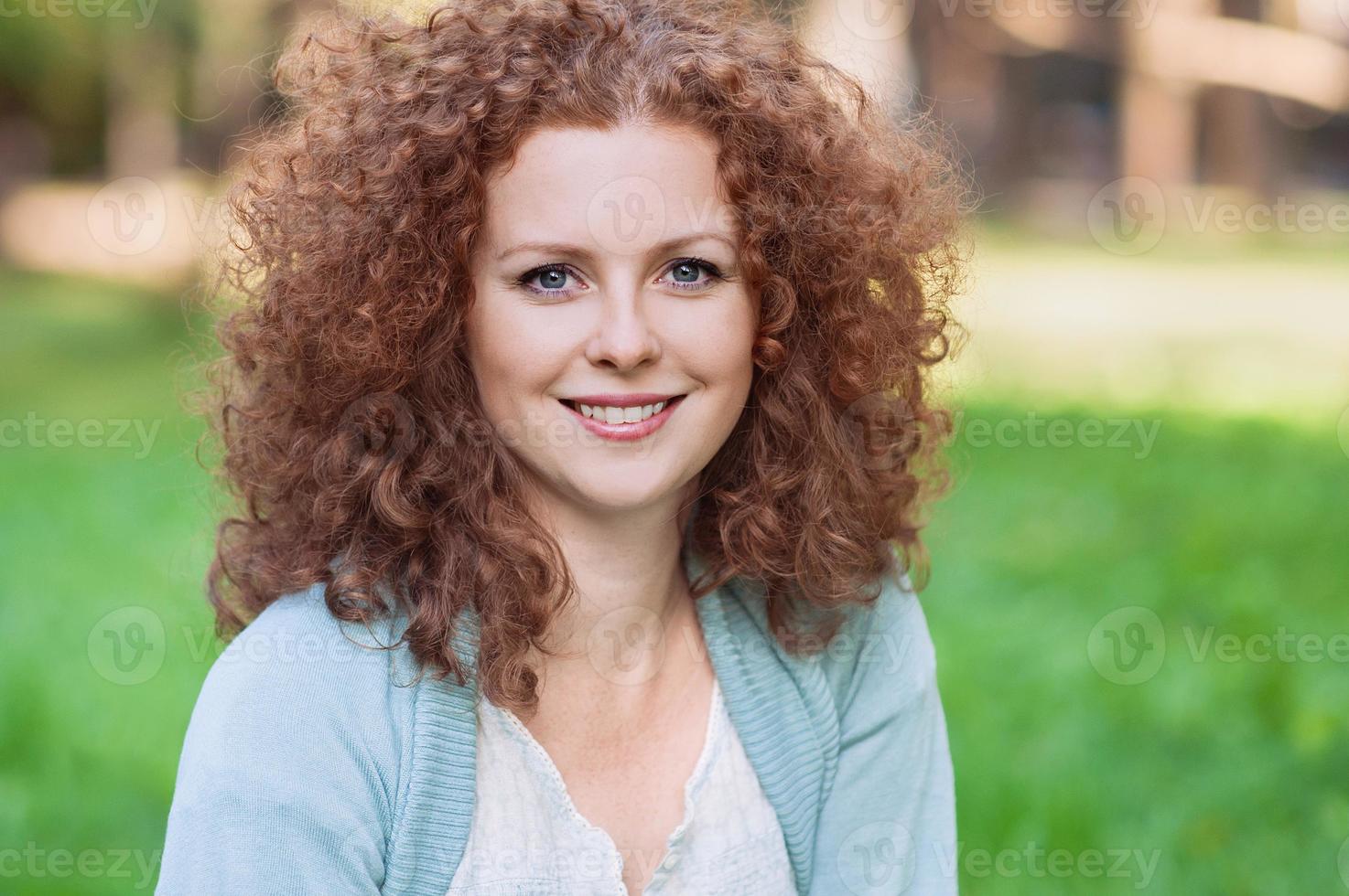 Smiling young woman outdoors photo