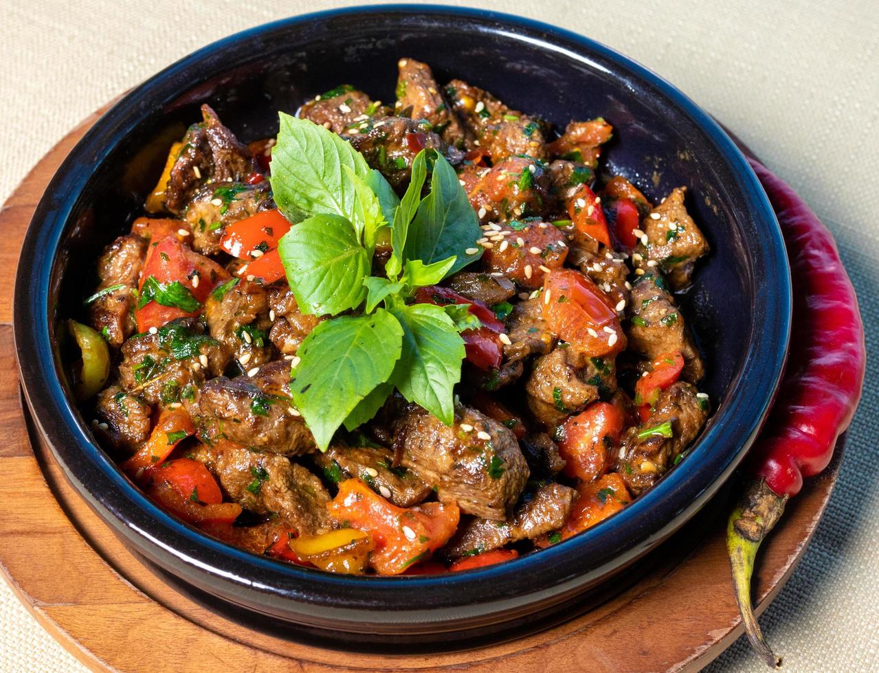 Eggplant, tomato, vegetable salad on the wooden plate photo