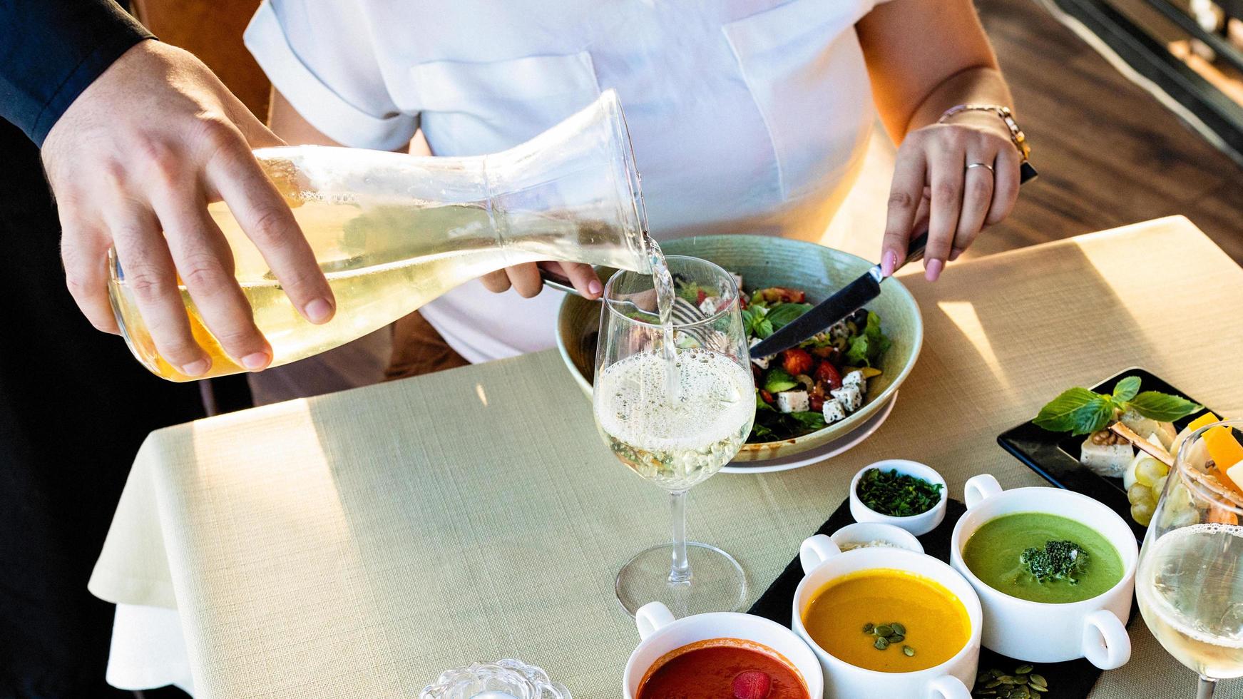 Server pouring wine into glass photo