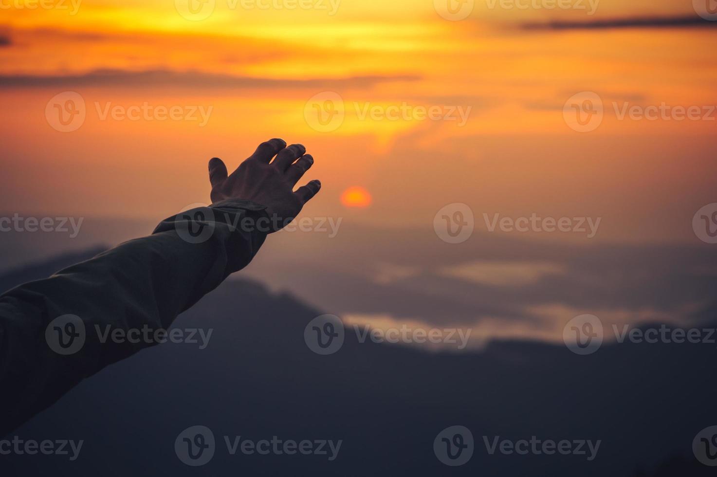 Touch the Sky concept Man Hand and Sunset Travel Lifestyle photo