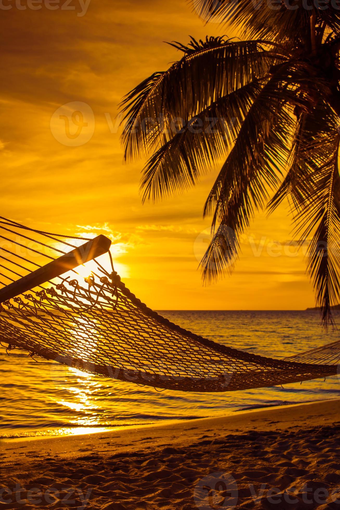Hammock with palm trees on a beautiful beach at sunset 1355940 Stock
