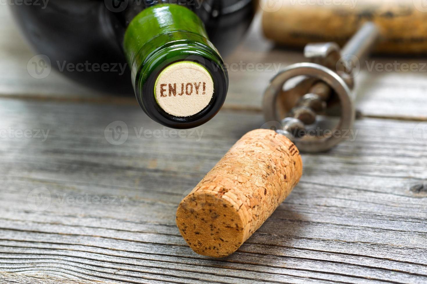 Unopened Red Wine Bottle with opener in background photo