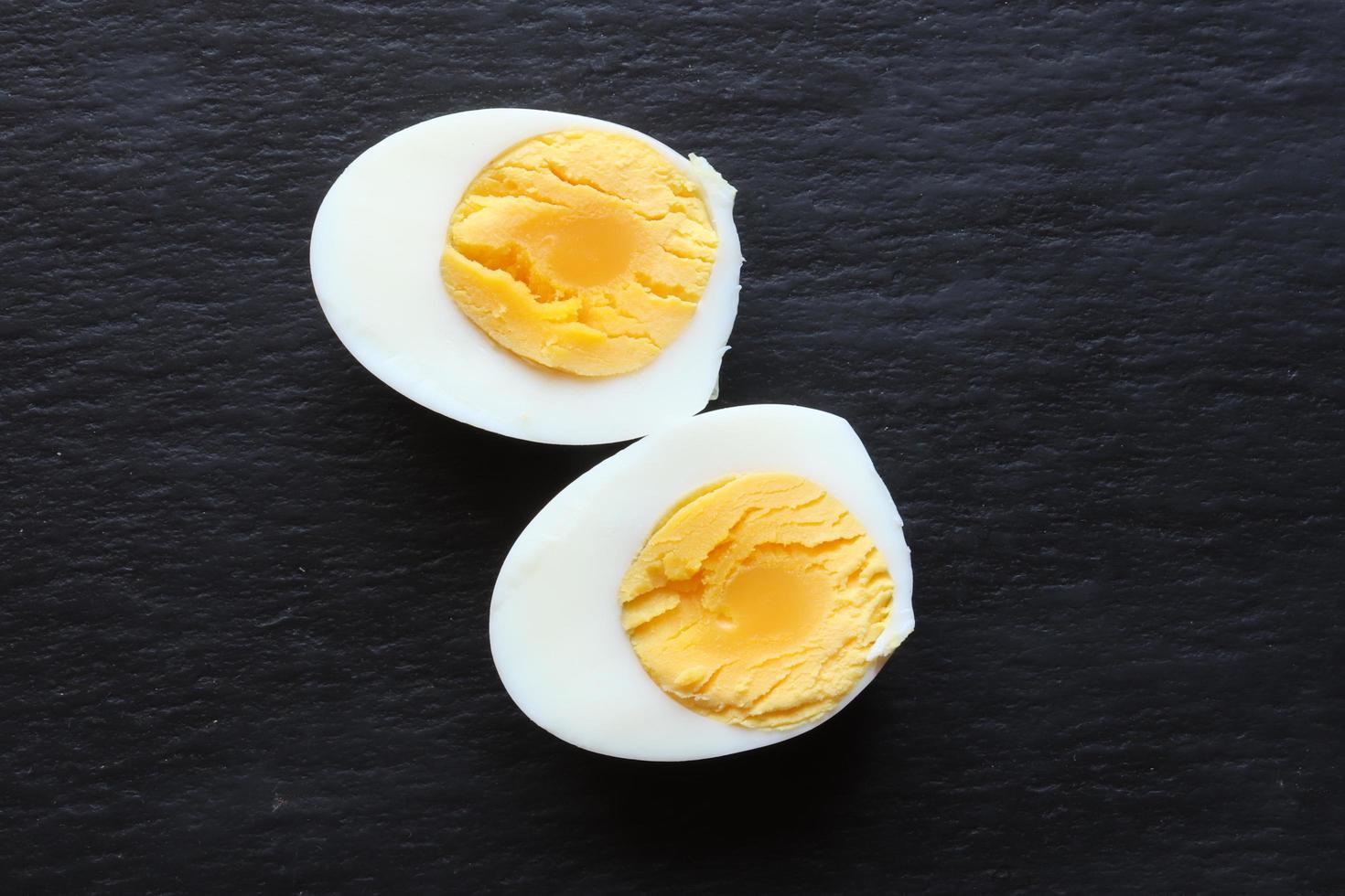 Sliced hard boiled egg on a slate background photo