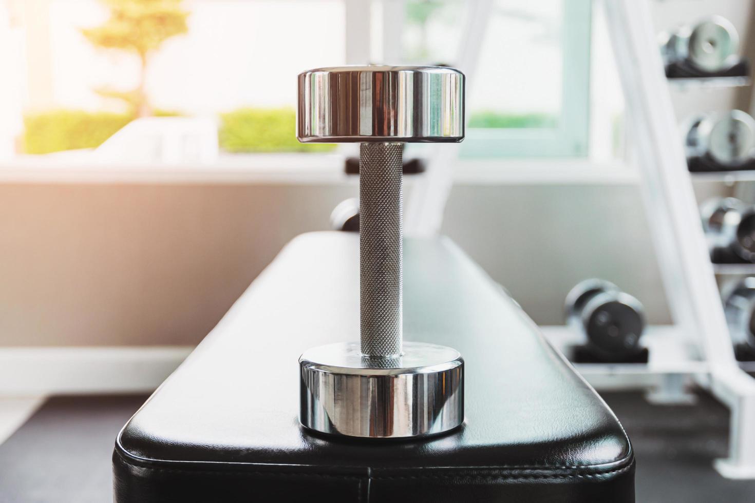 Steel dumbbells placed on the seat photo