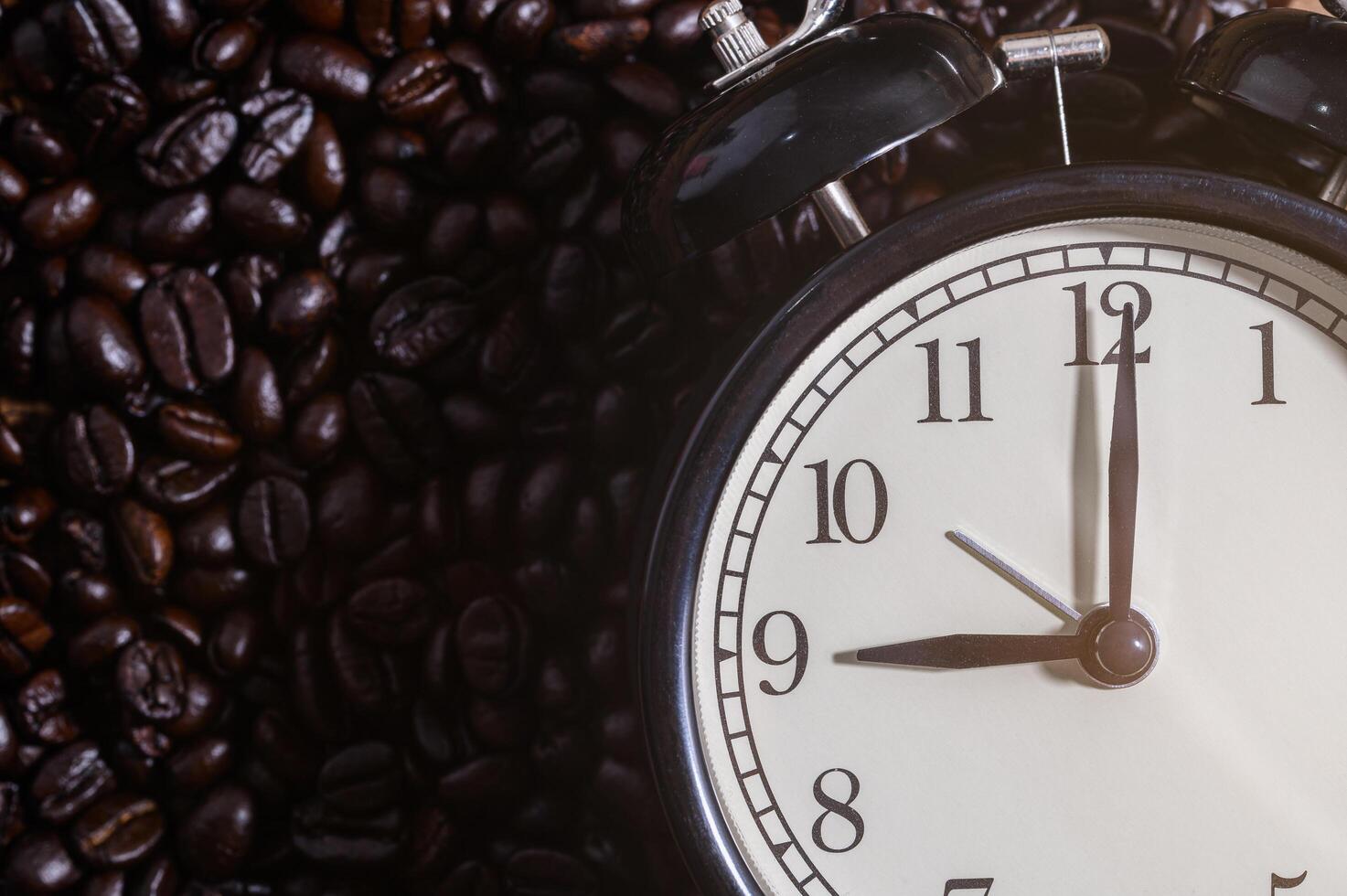Clock on coffee beans photo