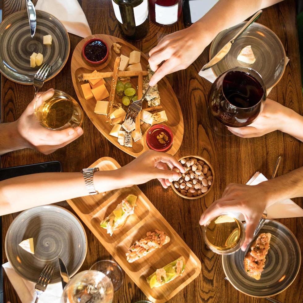People drinking wine and eating snacks photo