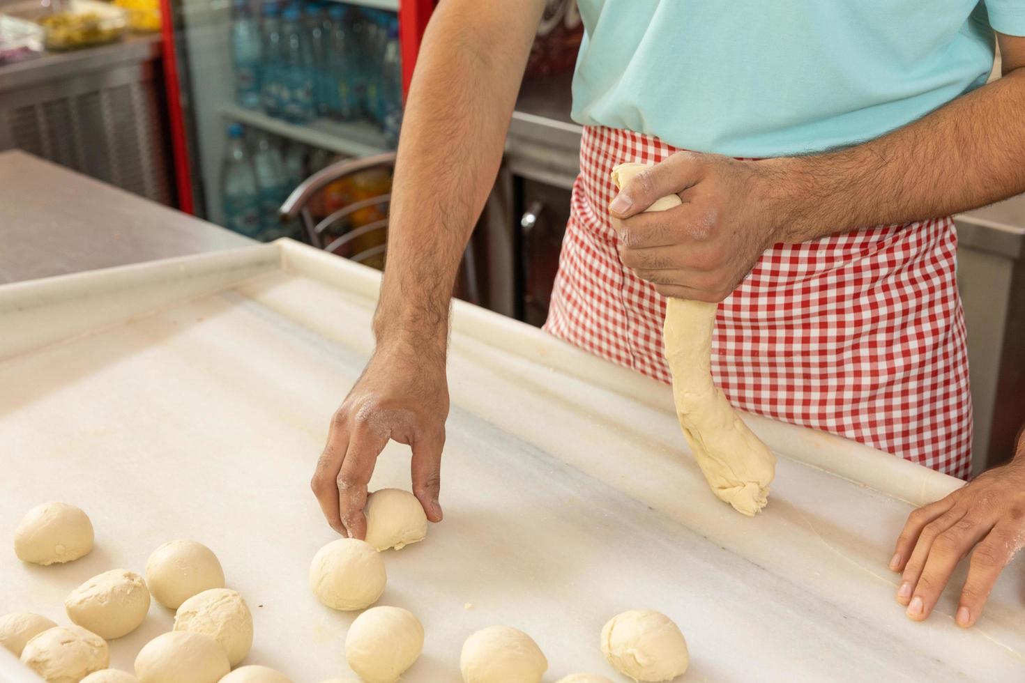 Restaurant chef rolling dough balls photo