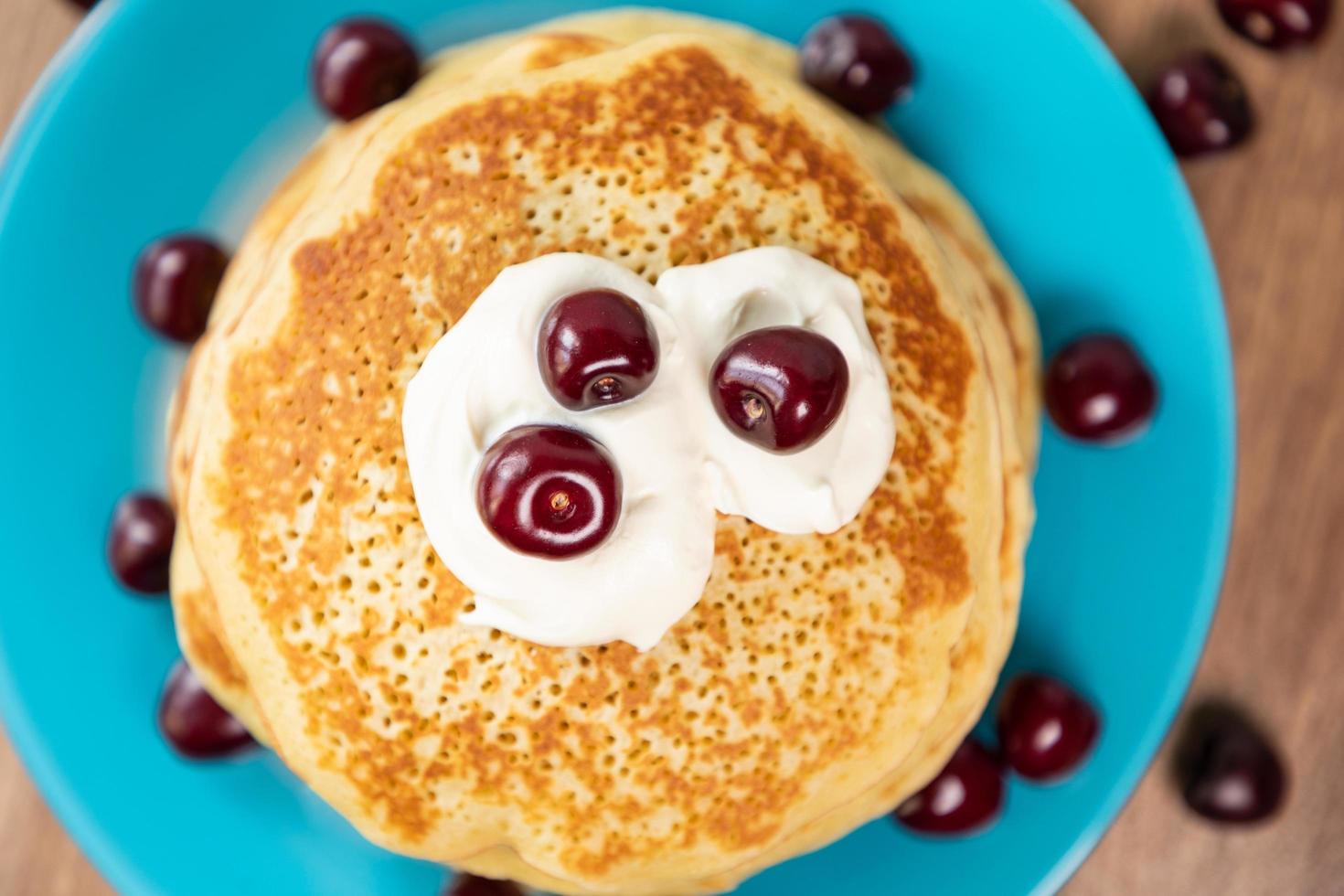 Pancakes with yogurt and cherry photo