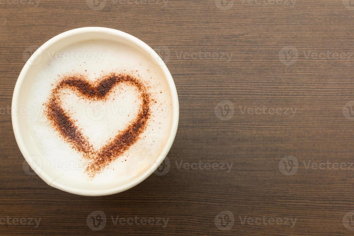 Paper cup of coffee with heart symbol photo