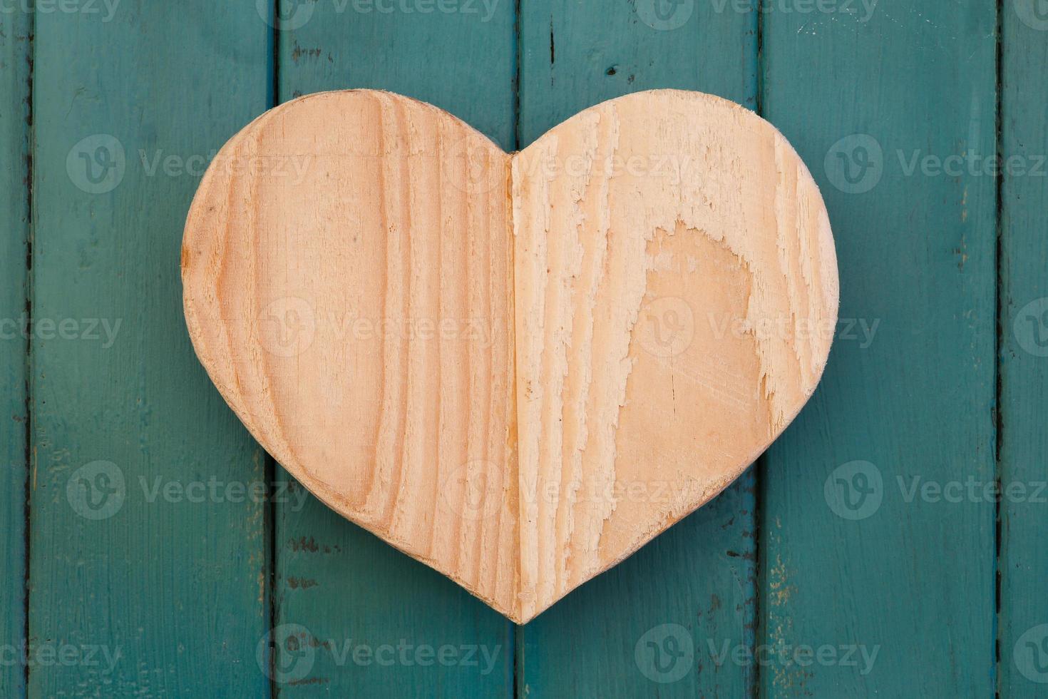 Love Valentines wooden heart on turquoise painted background photo