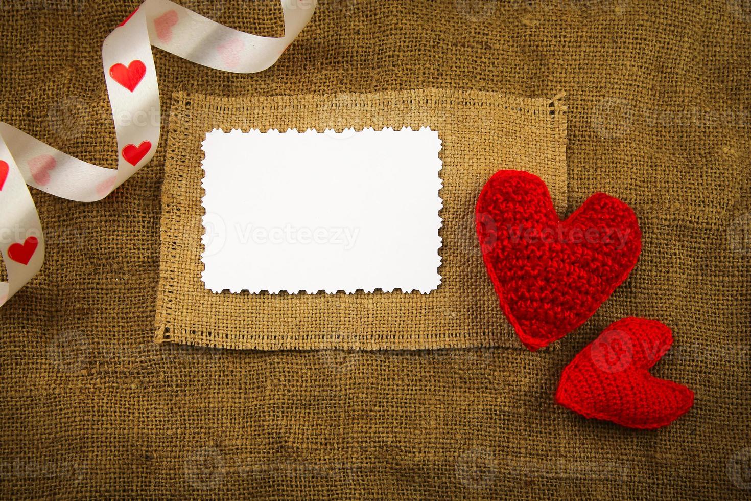 Knitting hearts on the sackcloth photo