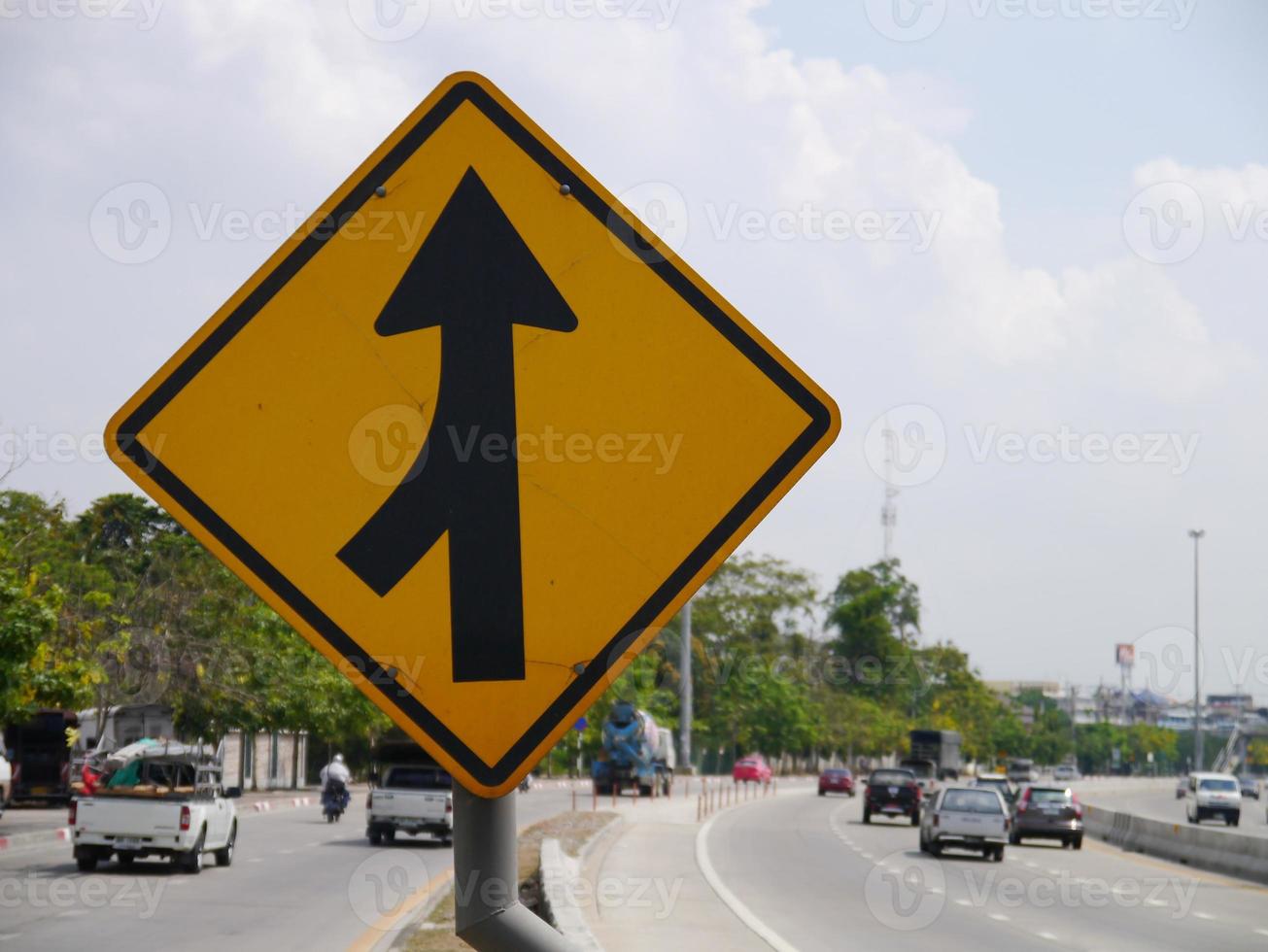 Curved Road Traffic Sign on the road at country side photo