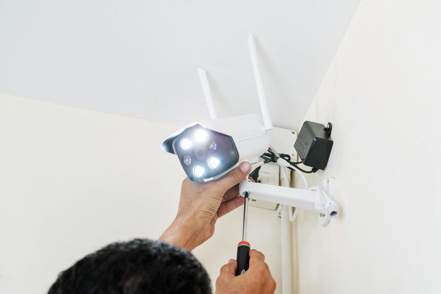 Technicians installing a wireless CCTV camera. photo