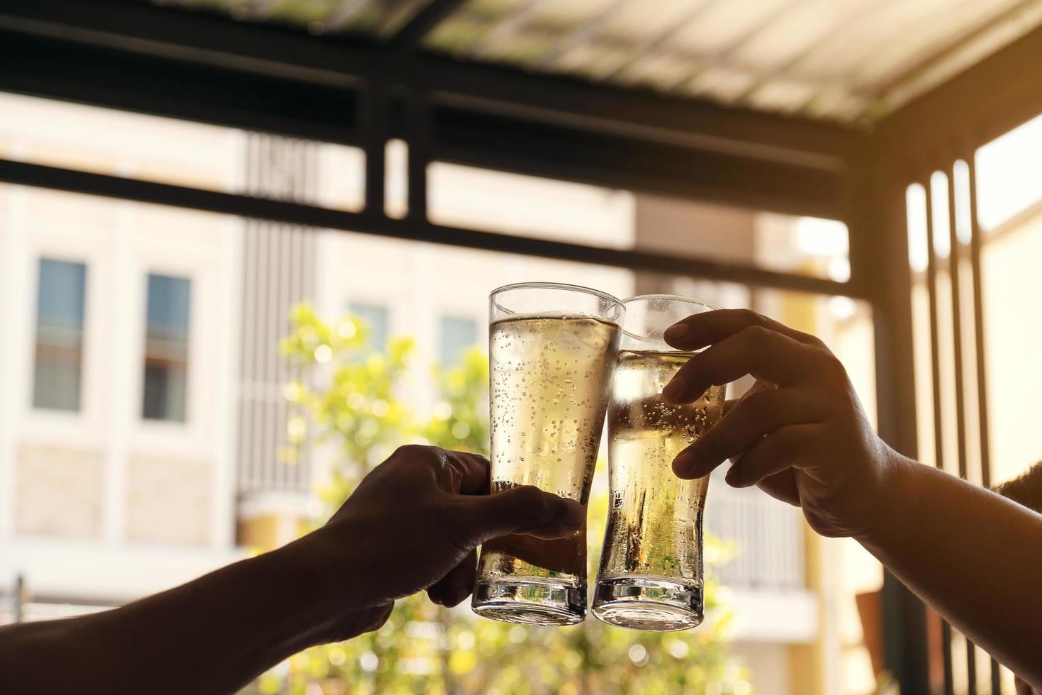 Cheers with two glasses of beer photo