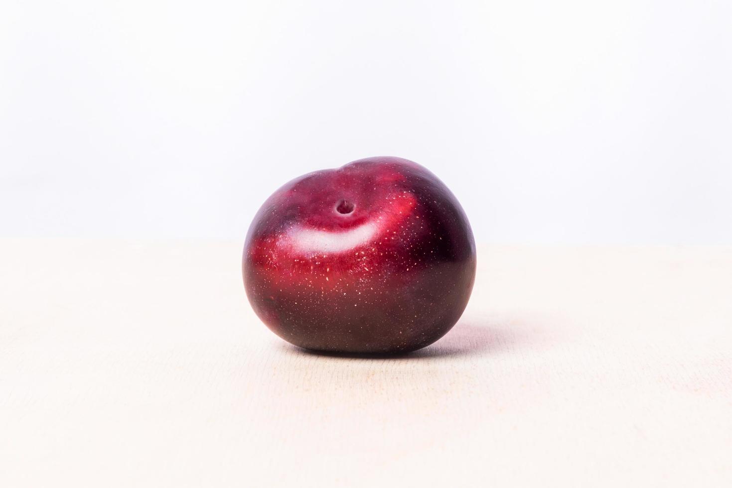 Red plum fruit on white background photo
