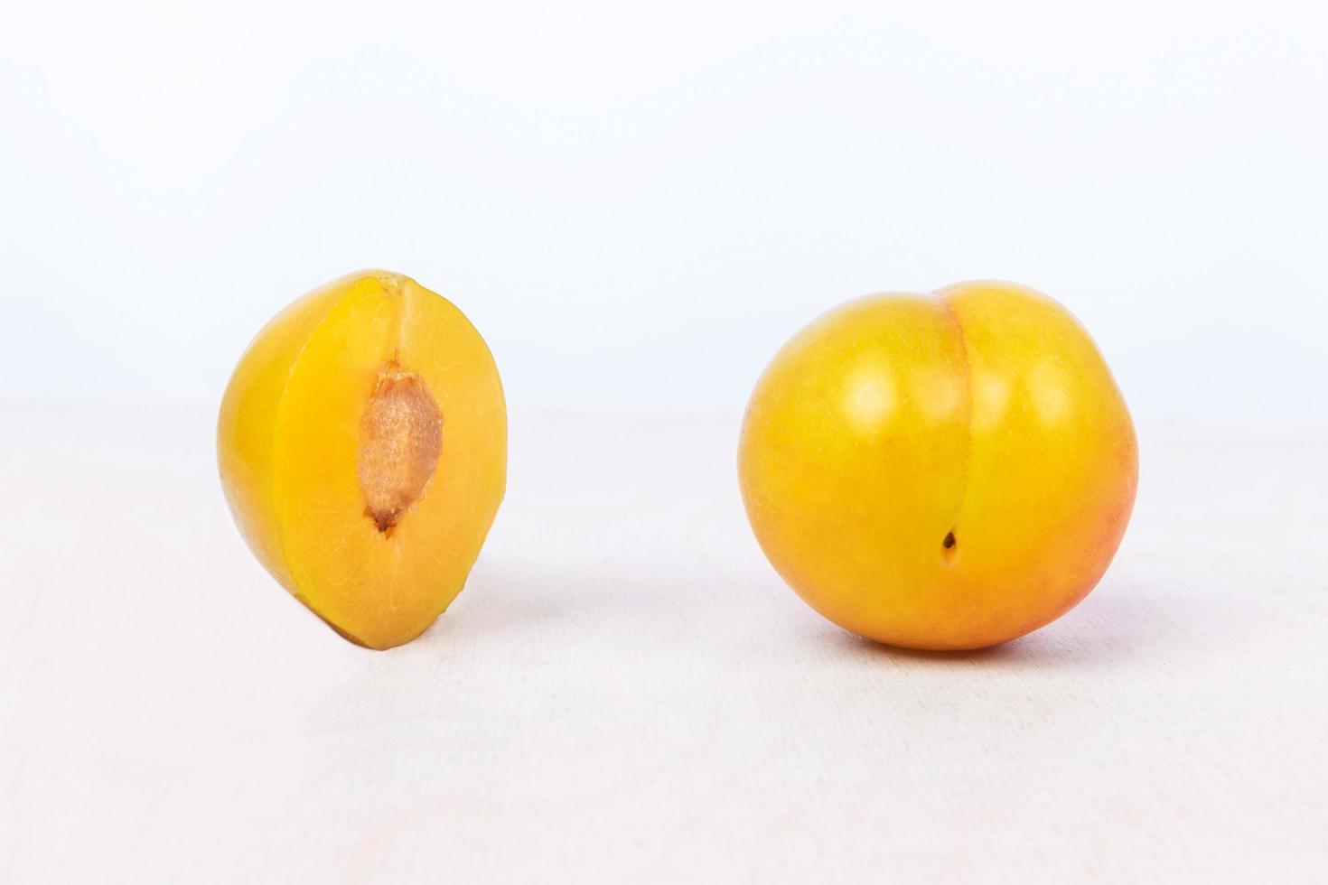 Yellow plum fruit on white background photo