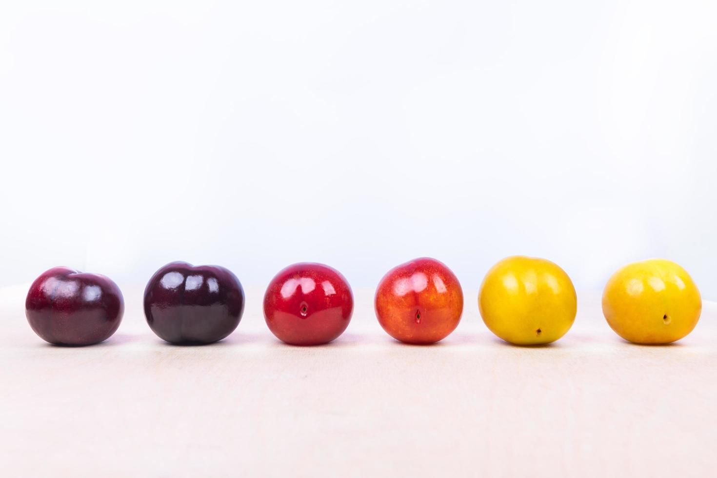 Red, yellow and purple plum fruit photo