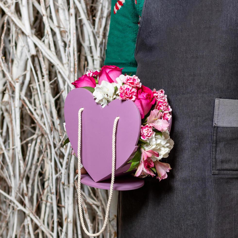 Person holding beautiful pink flowers photo