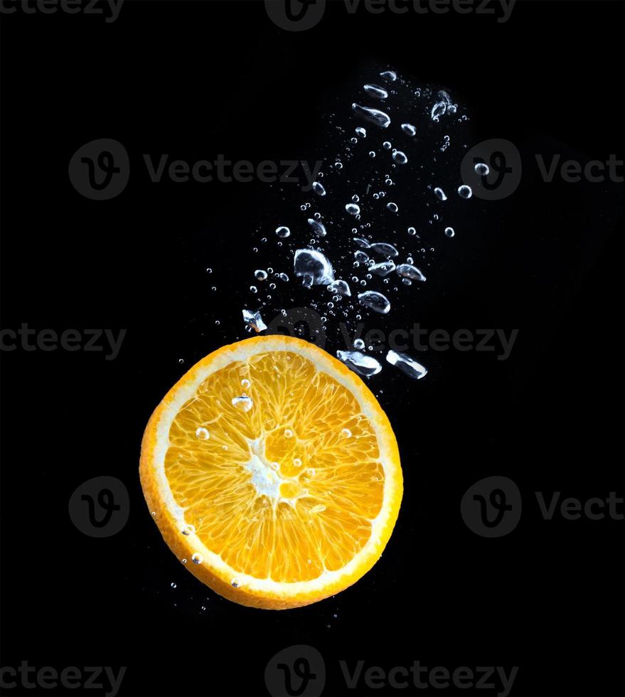 slice of orange in the water with bubbles photo