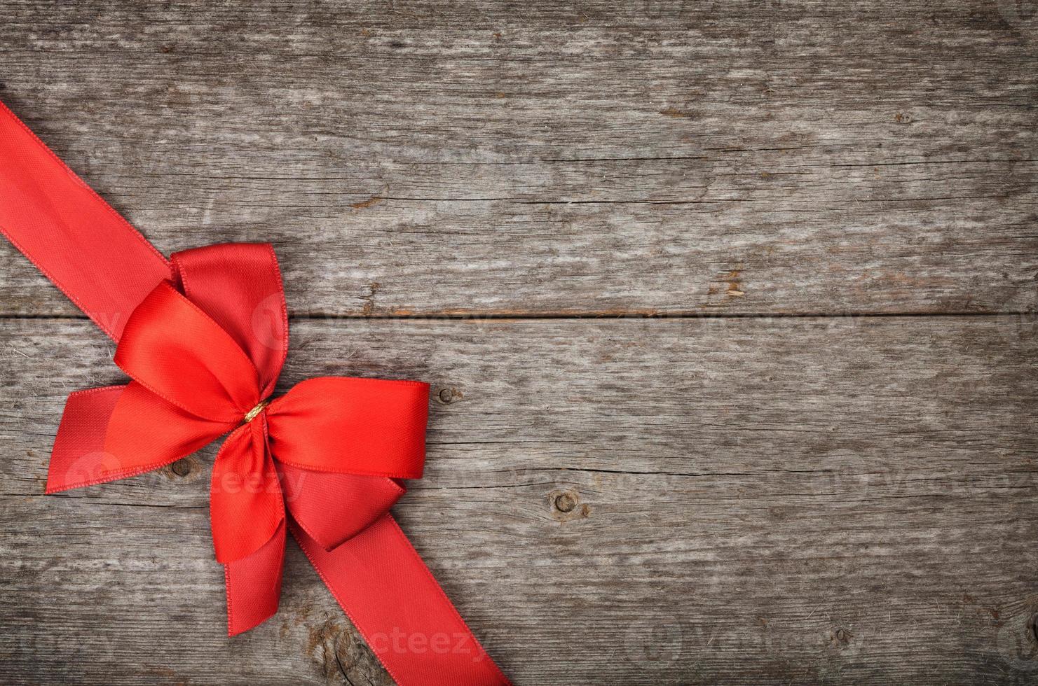 Wooden background with red bow and ribbon 1372014 Stock Photo at Vecteezy
