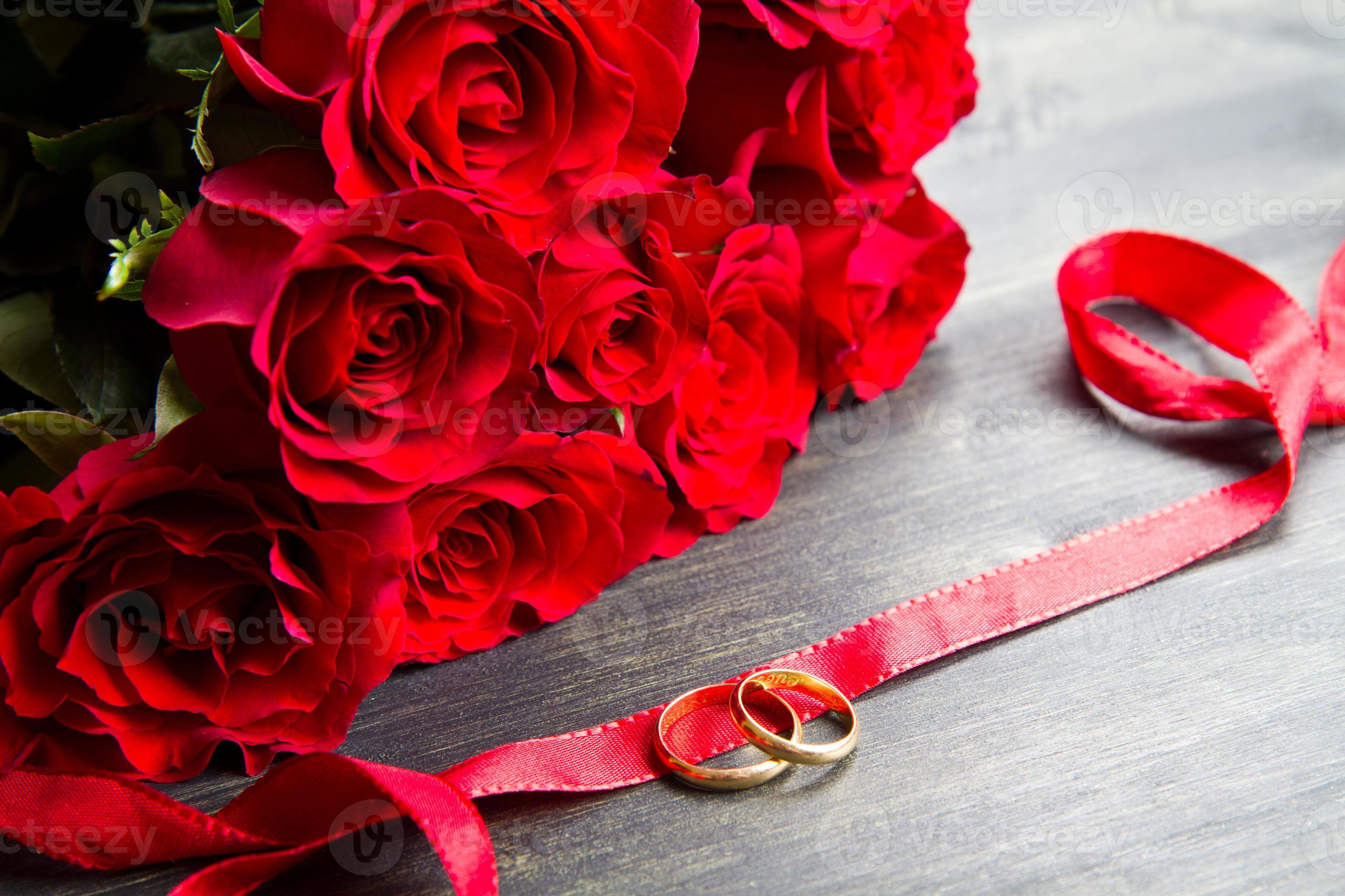 valentine’s day Red roses and wedding ring a wooden background 1372695