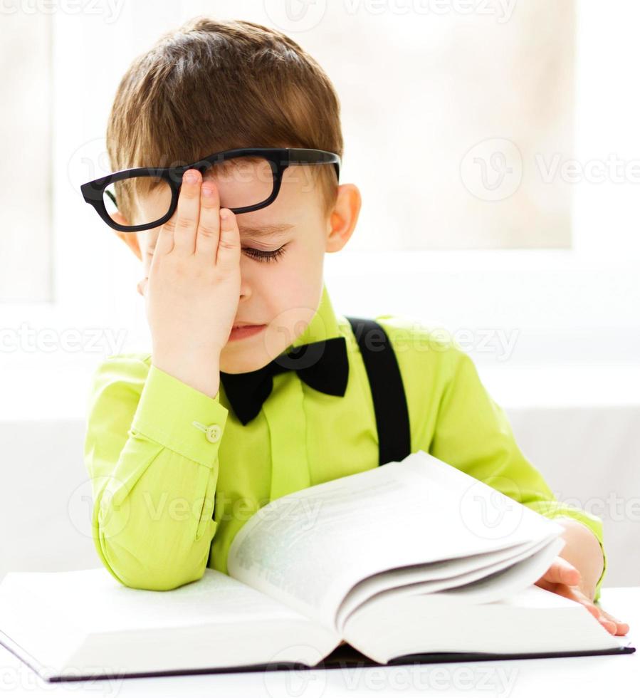 Little boy is reading a book photo