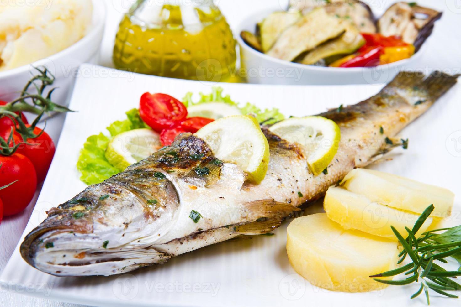 fish, sea bass grilled with lemon and  vegetables photo