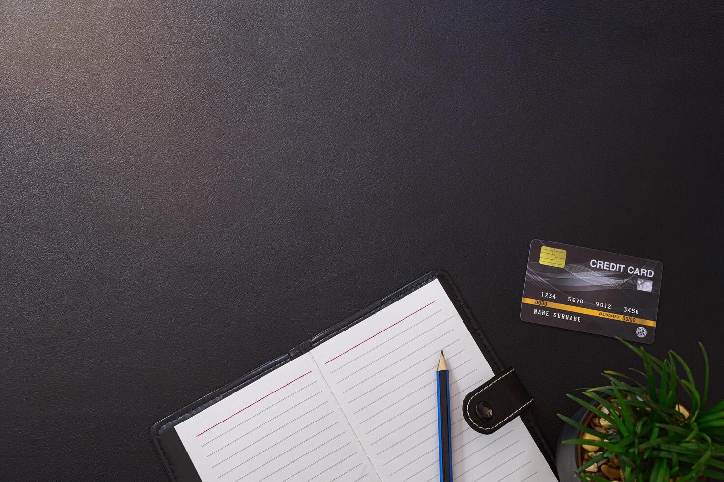 Record book, pencil and credit card on the desk photo