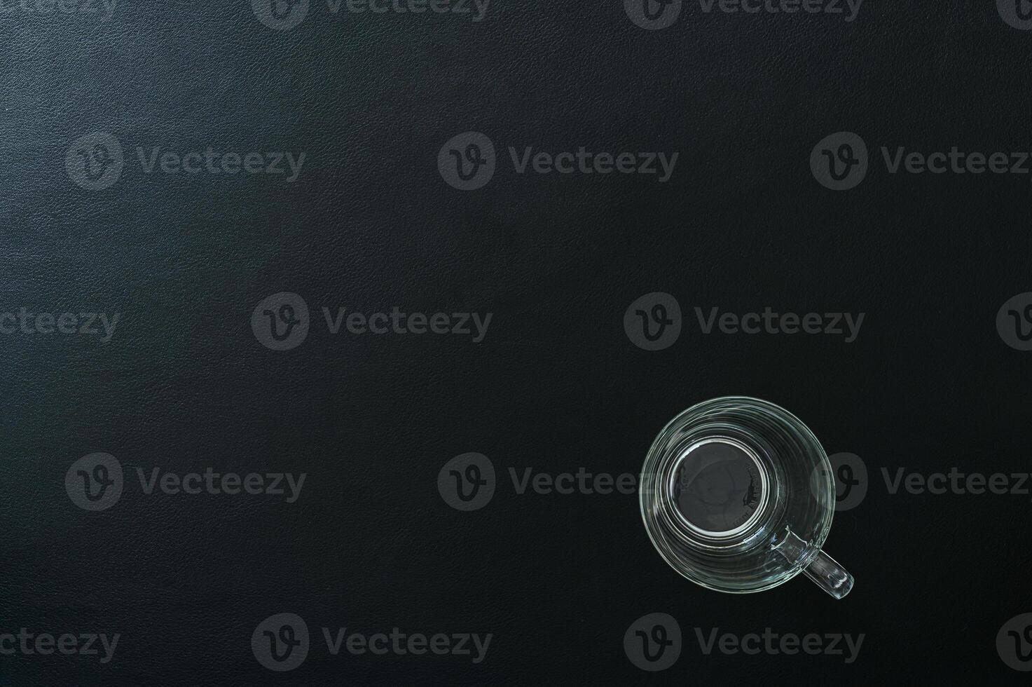 Empty glass on the desk, top view photo